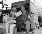 Red Cross nurses loading a truck with medical supplies during the interwar years