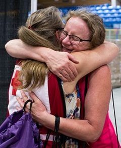 Canadian Red Cross volunteer hugs a woman