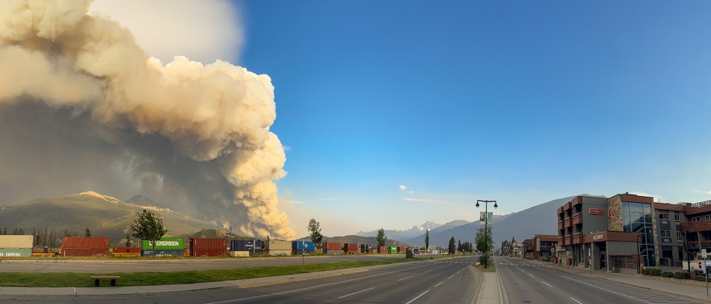 Thick smoke billows into the sky, a visible sign of the ongoing wildfire in Alberta.