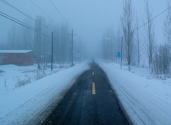 An empty snow covered road