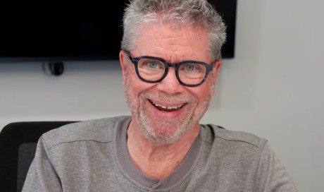 Murray Hill wearing glasses and smiling at the camera