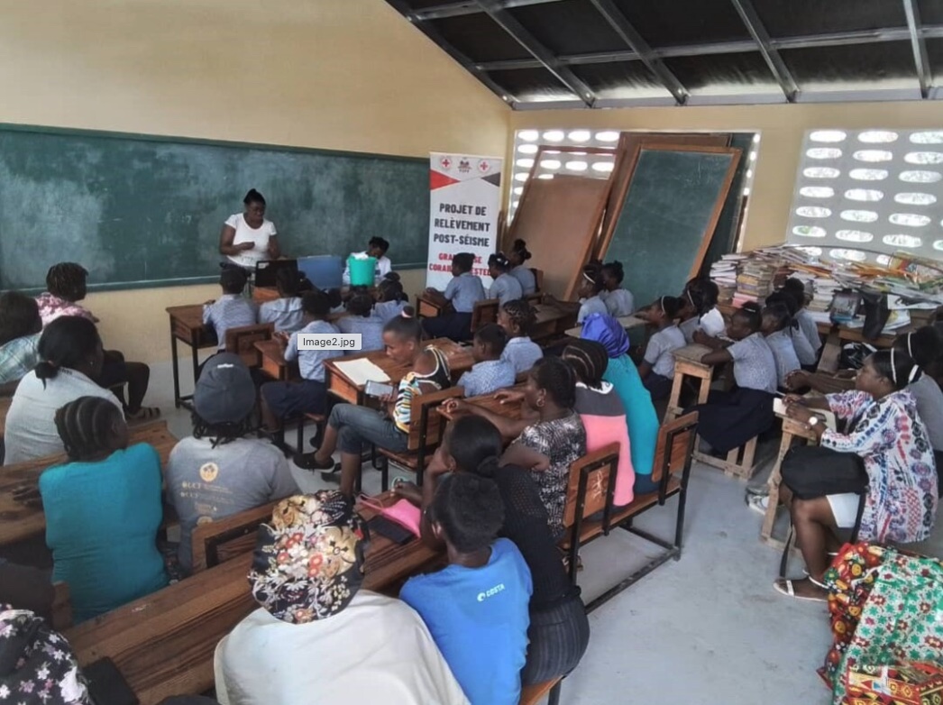 A classroom full of students listening attentively to a presentation.