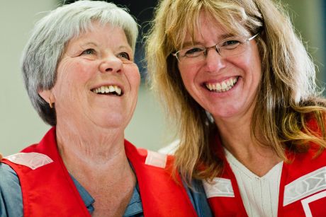 Two Canadian Red Cross volunteers enjoy a moment of laughter with big smiles.