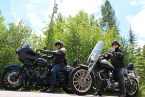 Two people driving motorcycles.