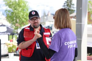 Red Cross personnel talking to another person at the Re-Entry Support Centre in Jasper.