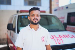 A headshot of  Yehya in front of an ambulance.