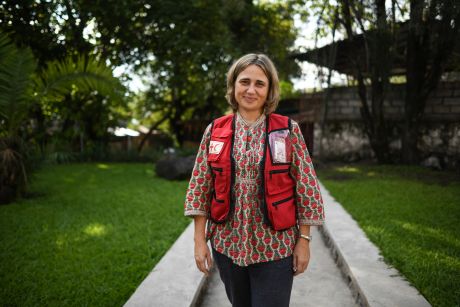 Maria Muñoz-Bertrand wearing a Red Cross vest, photographed outside.
