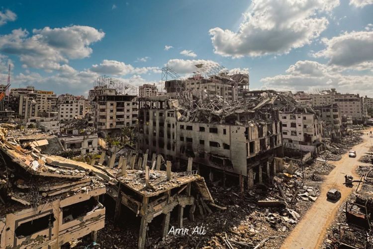 A wide-angle landscape photo of demolished and damaged buildings in Gaza City.