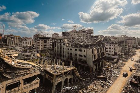 A wide-angle landscape photo of demolished and damaged buildings in Gaza City.