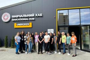 Lynn Henderson and a group of nurses who received training stand in front the educational hub in Lviv for a group photo.