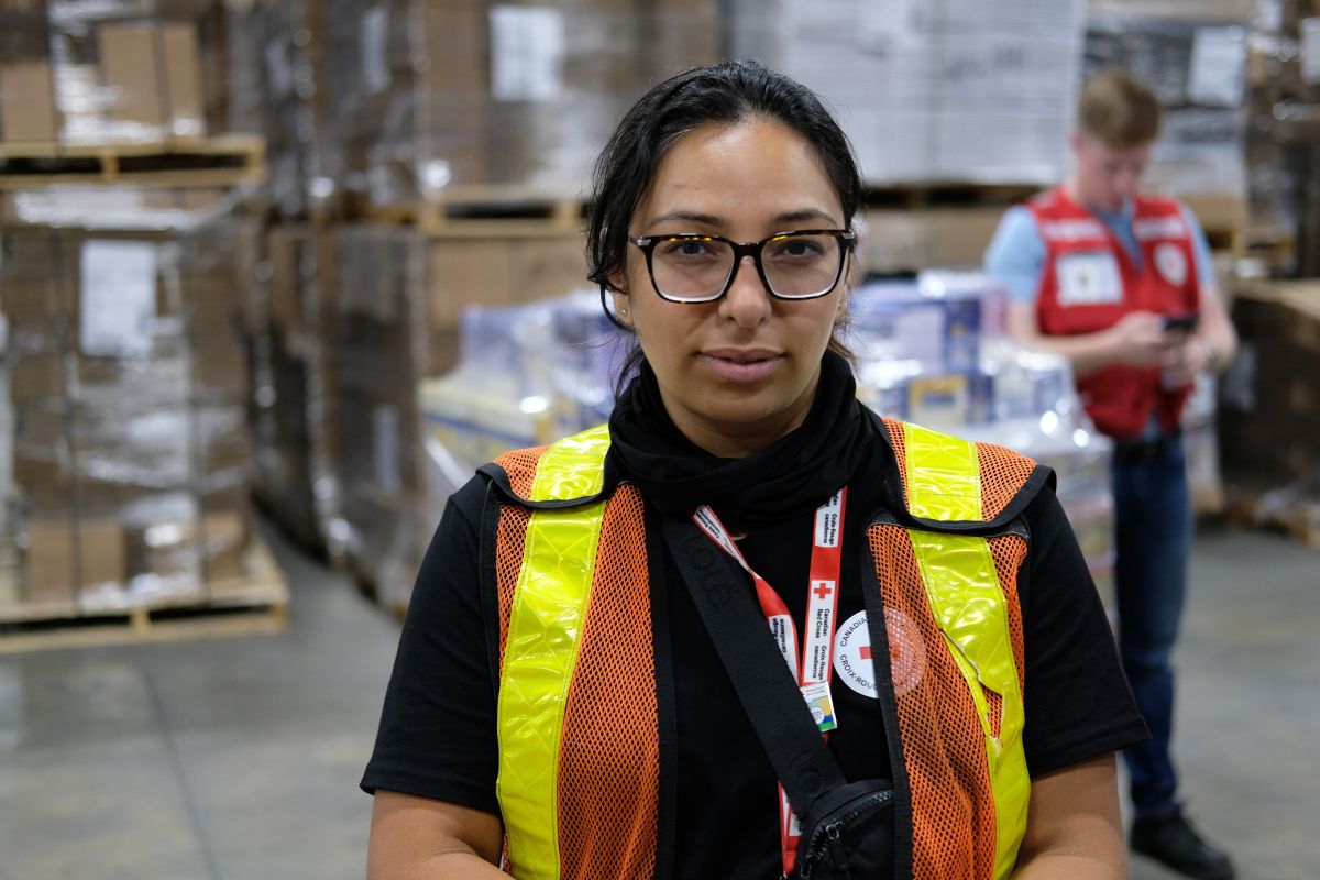 Dans un entrepôt, Fatima Alkhazandar prend la pose pour une photo.