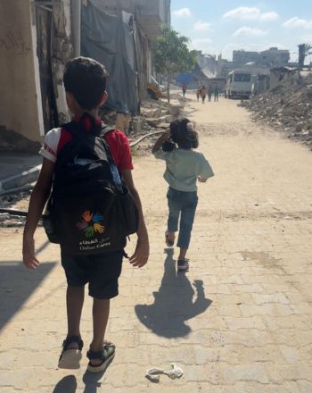 Amr's children walking down a street.