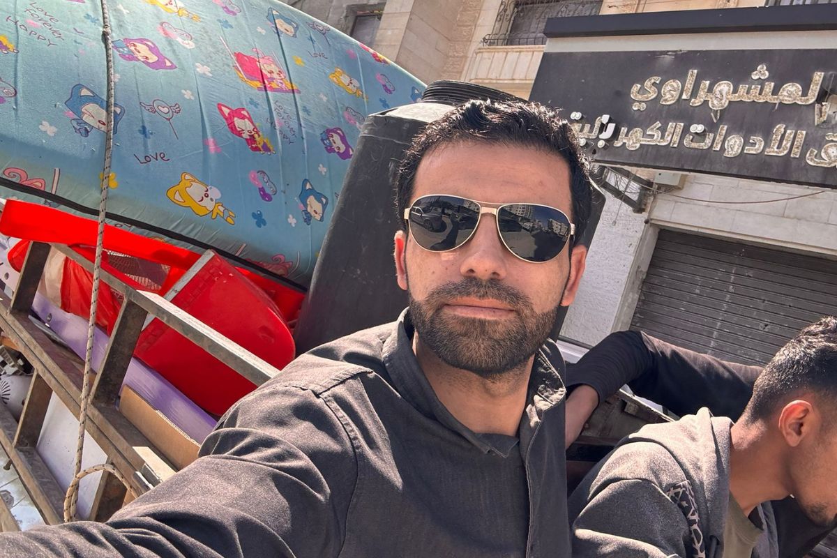 A selfie of Amr in the passenger seat of a truck.