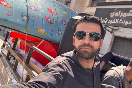 A selfie of Amr in the passenger seat of a truck.