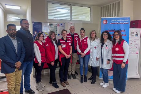 Red Cross personnel pose for a group photo with staff of the Primary Healthcare centre.    