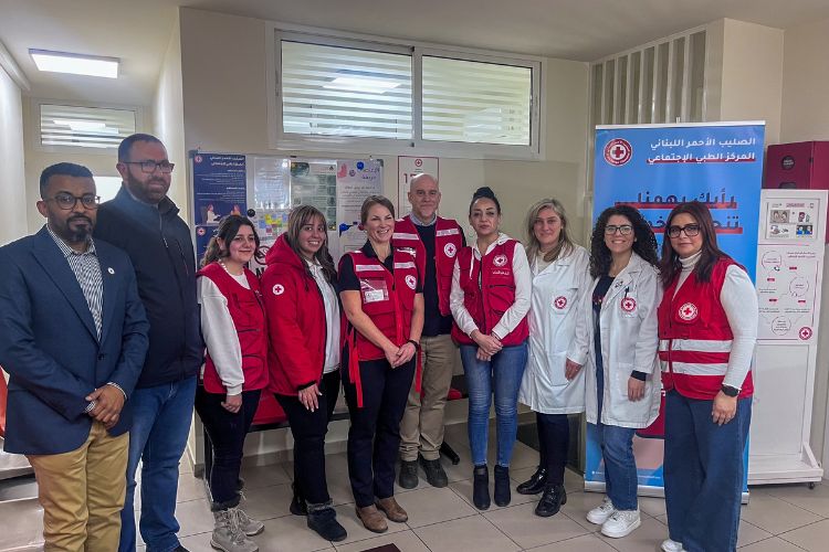 Red Cross personnel pose for a group photo with staff of the Primary Healthcare centre.