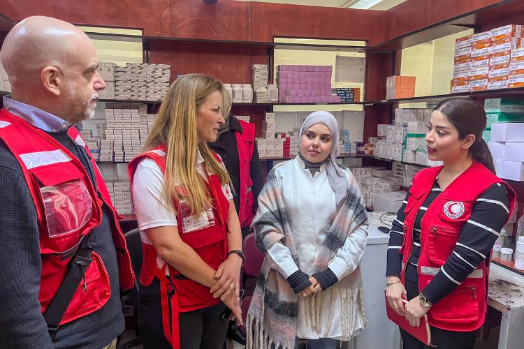 Red Cross personnel meet with pharmacy staff at the Sayeda Zainad Primary Health Centre.