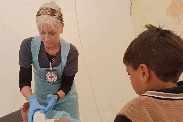 Terry providing rehabilitative care to a child at the Red Cross Field Hospital in Rafah.
