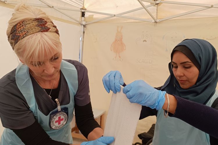 Red Cross personnel providing rehabilitative care at the Red Cross Field Hospital in Rafah.