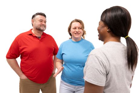 Three happy people smiling and talking about the benefits of exercise for physical and mental health.
