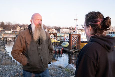 Two people engaged in a serious conversation, representing the impact of stress on mental health.
