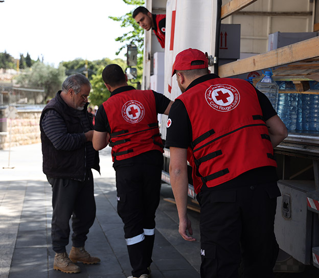 Members of the Red Cross unload supplies from a truck in Lebanon. 