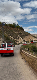 Three Ambulances driving along the road, highlighting the urgent response to the Middle East Humanitarian Crisis 