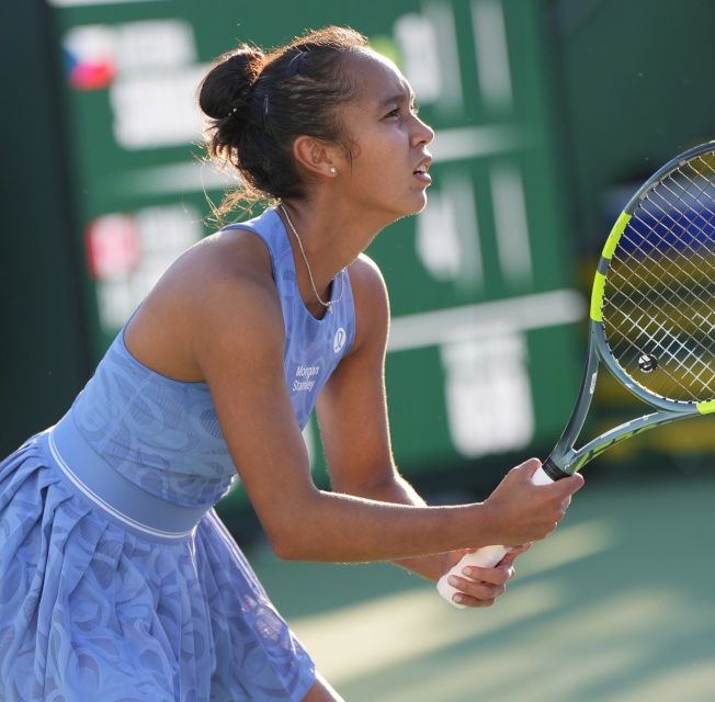 Tennis player Leylah Fernandez in a crouched ready position, eyes locked on the ball