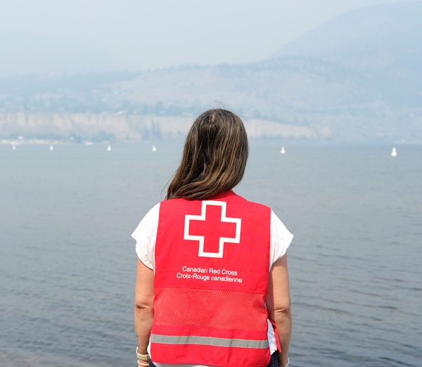 Staff from the Canadian Red Cross watches smoke rising from the Bald Range Fire, overlooking Okanagan Lake in Penticton.