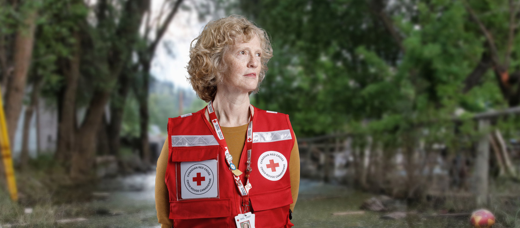 A dedicated Red Cross volunteer gazing to the right, ready to assist.