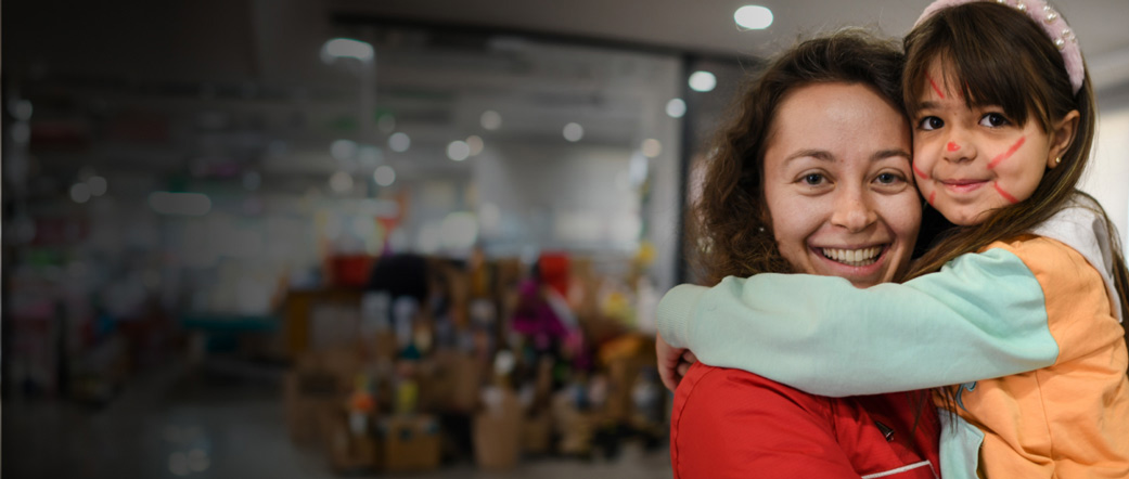 A woman and a child hugging.