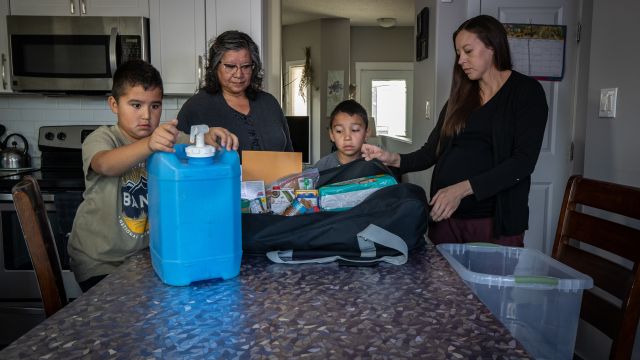 A family prepares an emergency preparedness kit 