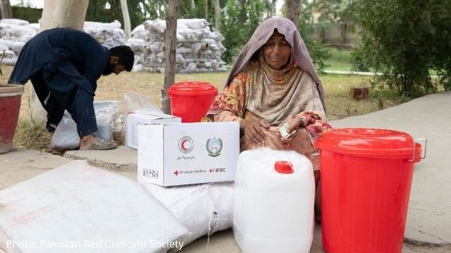 Woman receiving Red Cross supplies