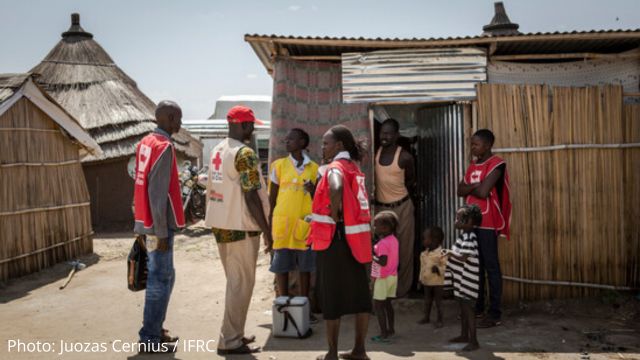 Mothers and their children waiting outside to be seen by health professionals in Sudan