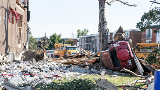 Debris and structural damage in a neighborhood after a tornado in Gatineau