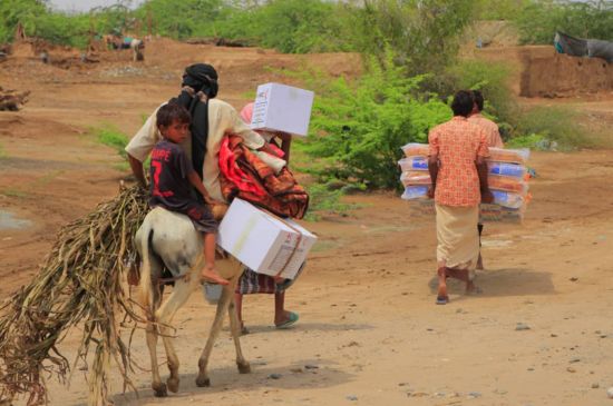 A group of people carrying humanitarian supplies in Yemen.