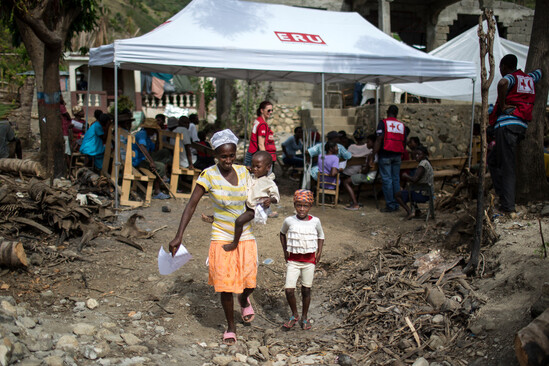 Red Cross helping a mother and her children after Hurricane Matthew