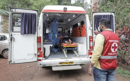 Indian Red Cross Society helping injured man.