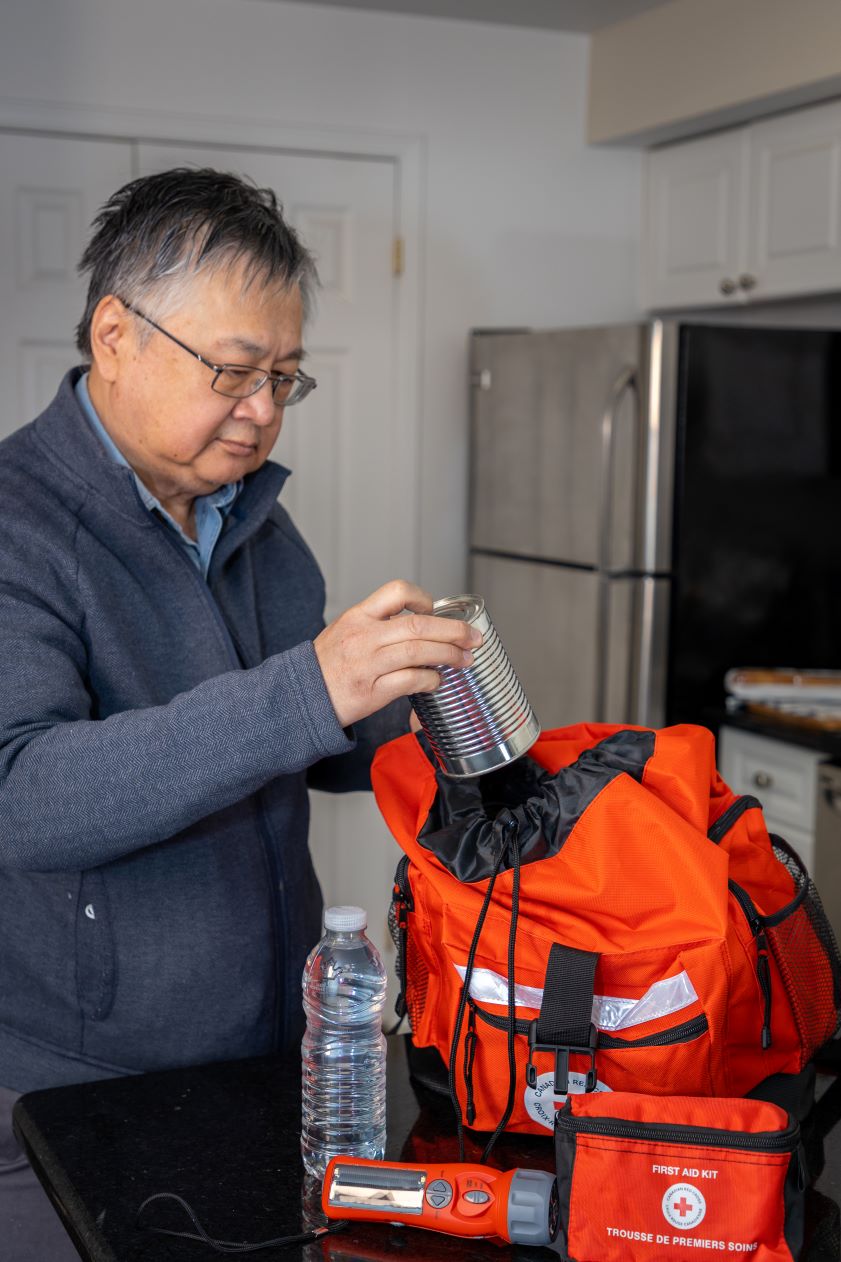 An older man packs an emergency Grab and Go bag.