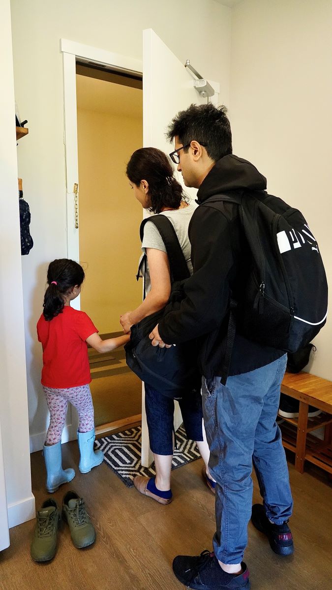 A man, woman, and child evacuate their house carrying Grab and Go bags.