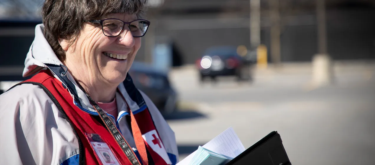 Woman wearing a Red Cross Canada vest smiling