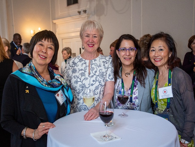 Four women at a table smiling for the camera