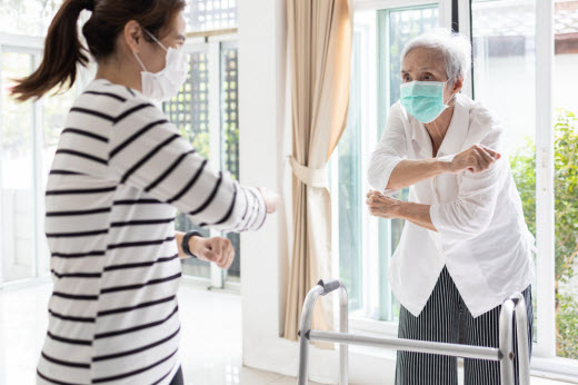 Woman showing exercises to an elderly person