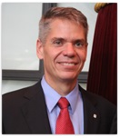 Man smiling wearing dark blue suit