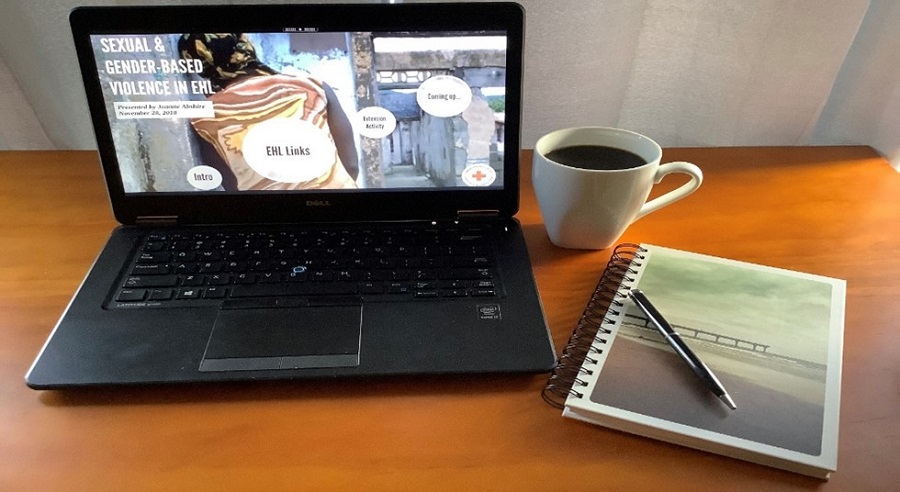 Laptop, notepad and cup of coffee on a desk