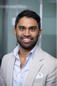 Man smiling wearing light grey suit