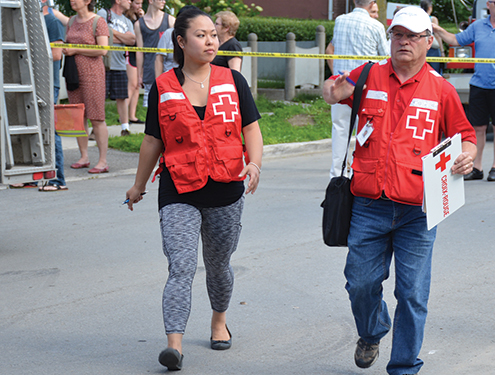 Canadian Red Cross volunteers and firefighters arriving to a site on fire