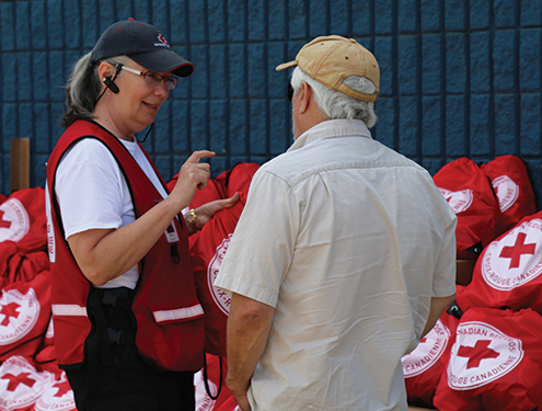 A Canadian Red Cross volunteer talking with a man