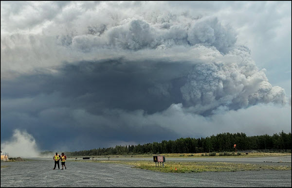 Clouds and smoke in the sky as community members prepare for an evacuation due to wildfires in Manitoba.